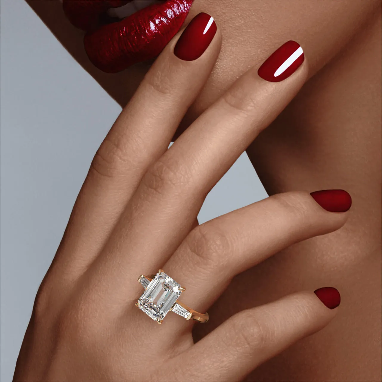 EMERALD CUT DIAMOND ENGAGEMENT RING WITH A BAGUETTE FLANK THREE PHASES SLIM SETTING IN 18K YELLOW GOLD