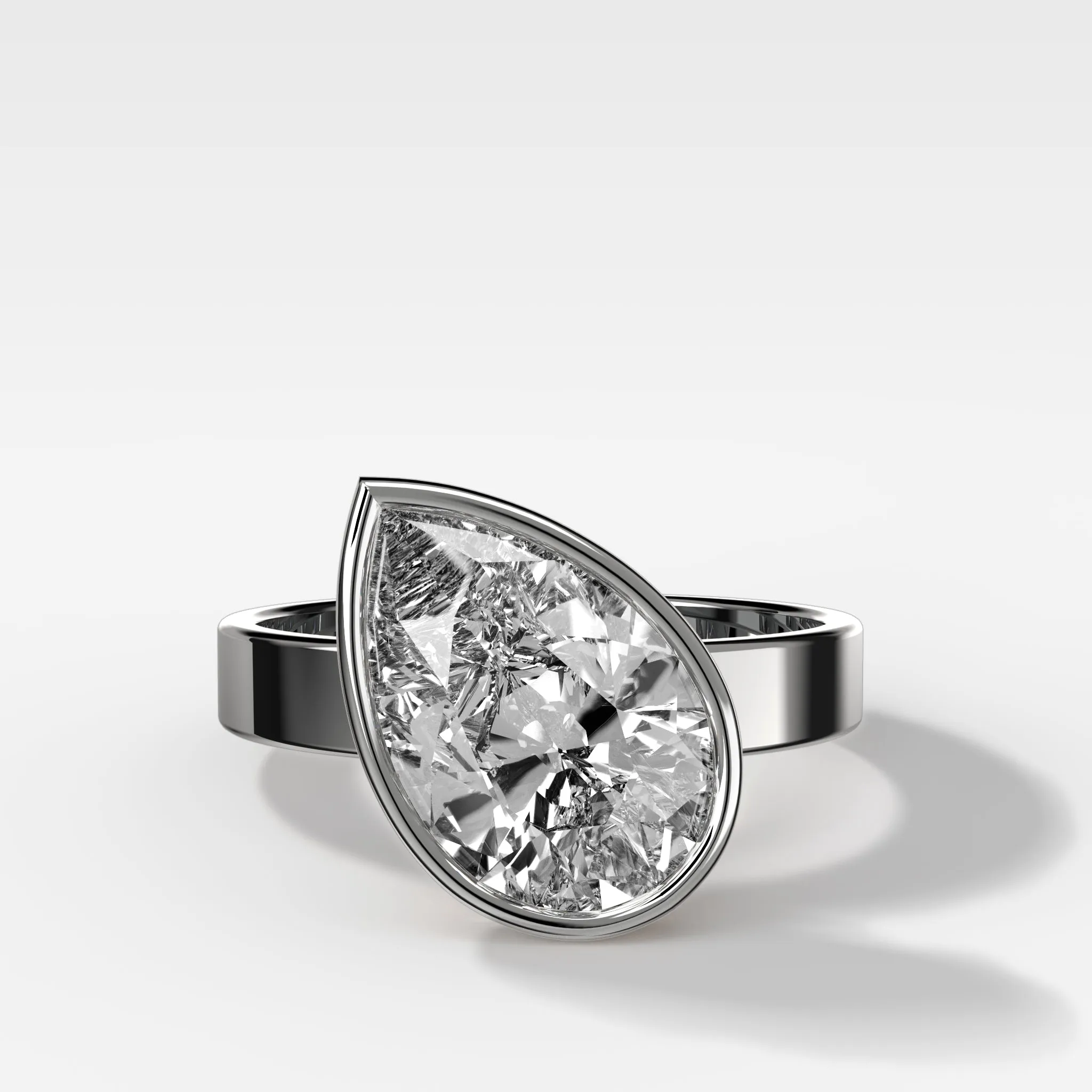 Finest Bezel Set Engagement Ring With Tilted Pear
