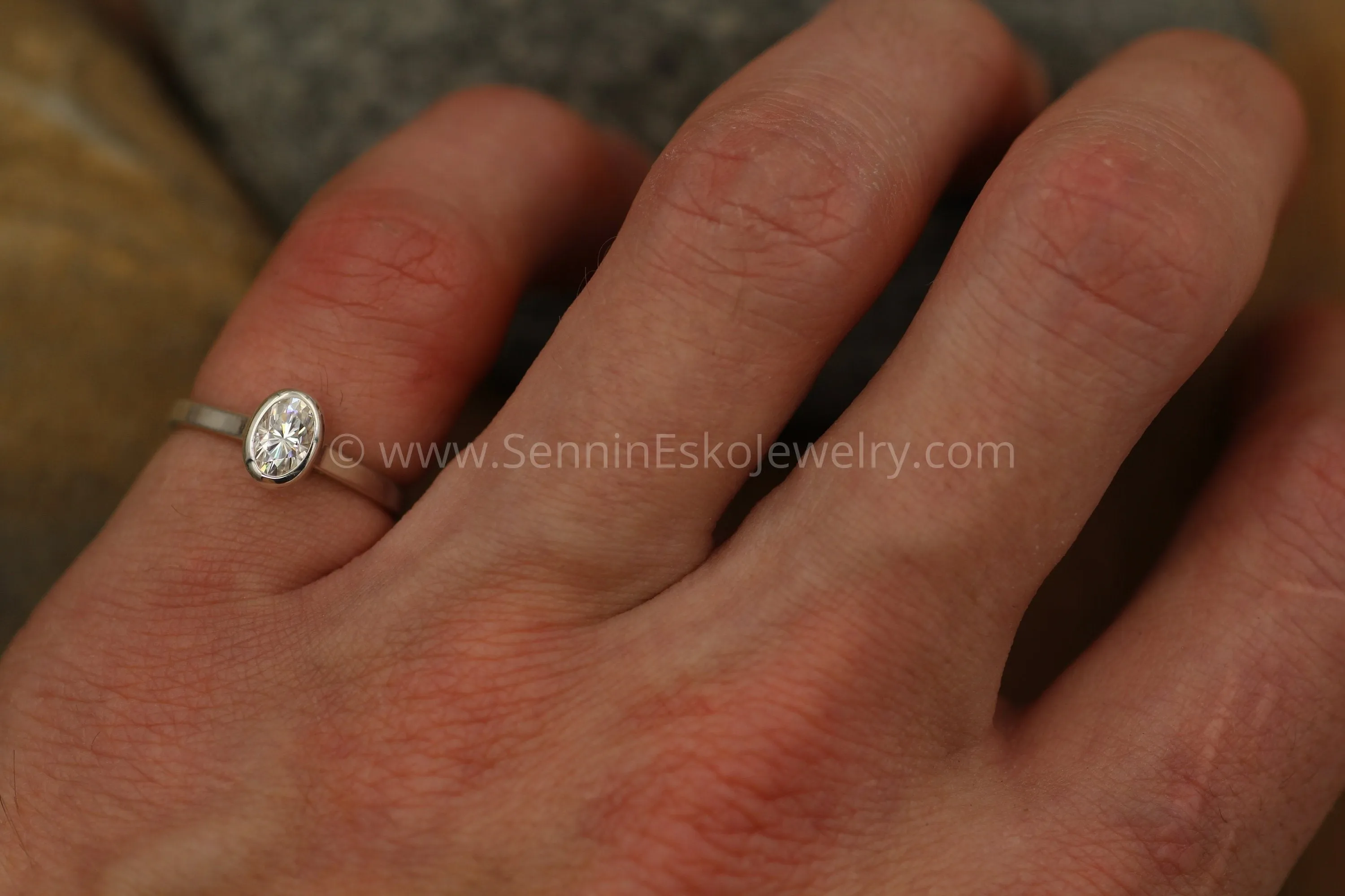 Moissanite 4x6mm Oval Peekaboo Bezel Solitaire Ring -  Forever One Moissanite