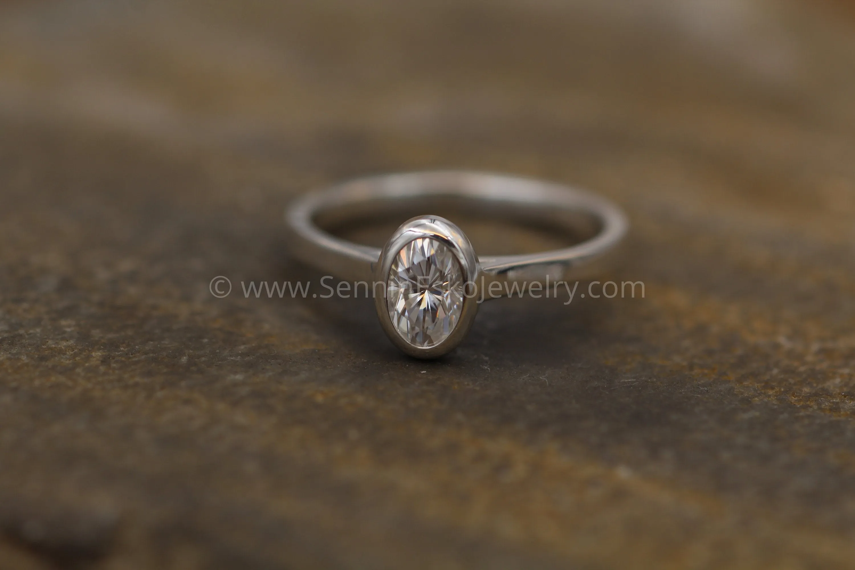 Moissanite 4x6mm Oval Peekaboo Bezel Solitaire Ring -  Forever One Moissanite