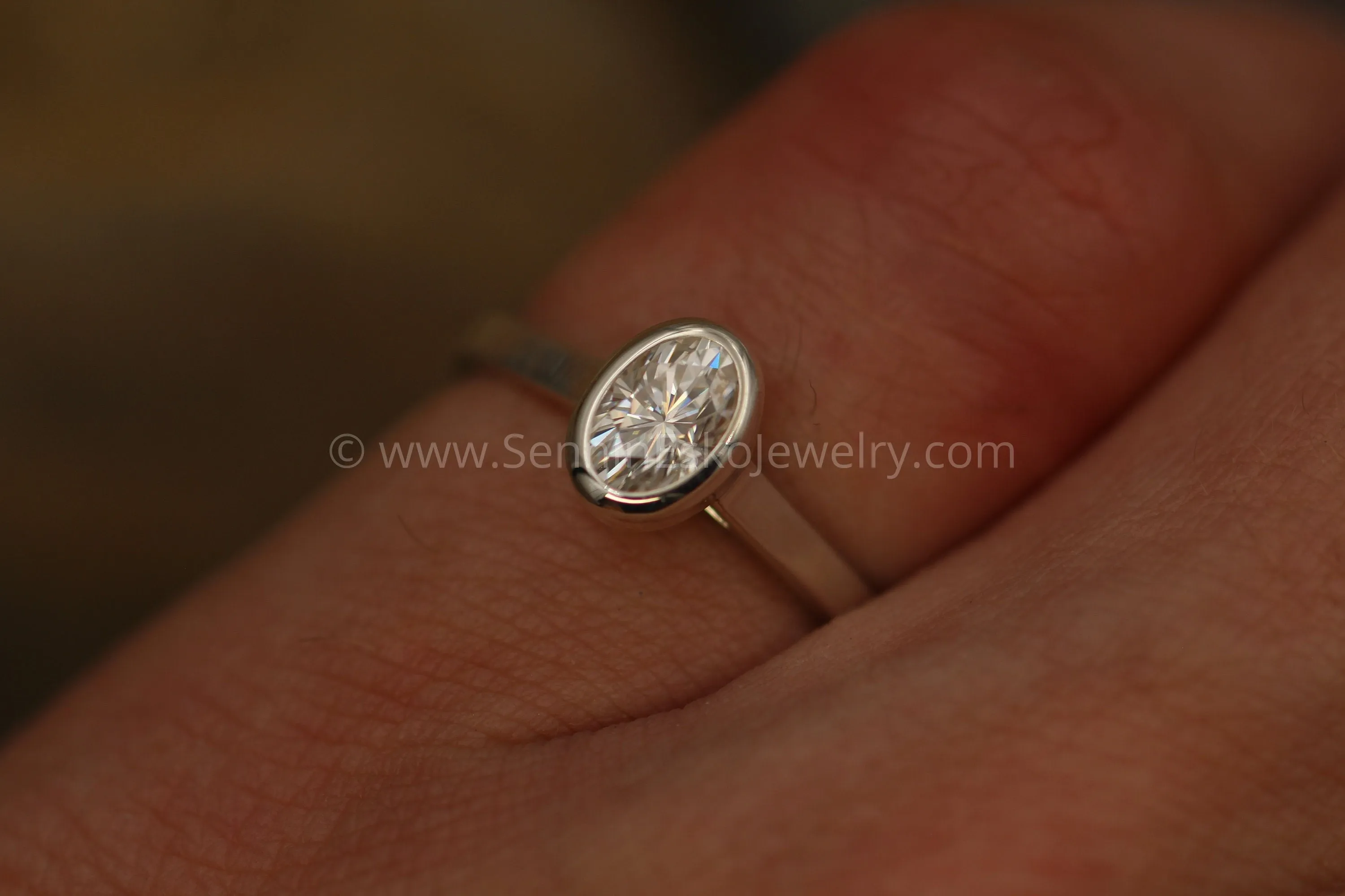 Moissanite 4x6mm Oval Peekaboo Bezel Solitaire Ring -  Forever One Moissanite