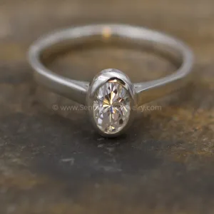 Moissanite 4x6mm Oval Peekaboo Bezel Solitaire Ring -  Forever One Moissanite
