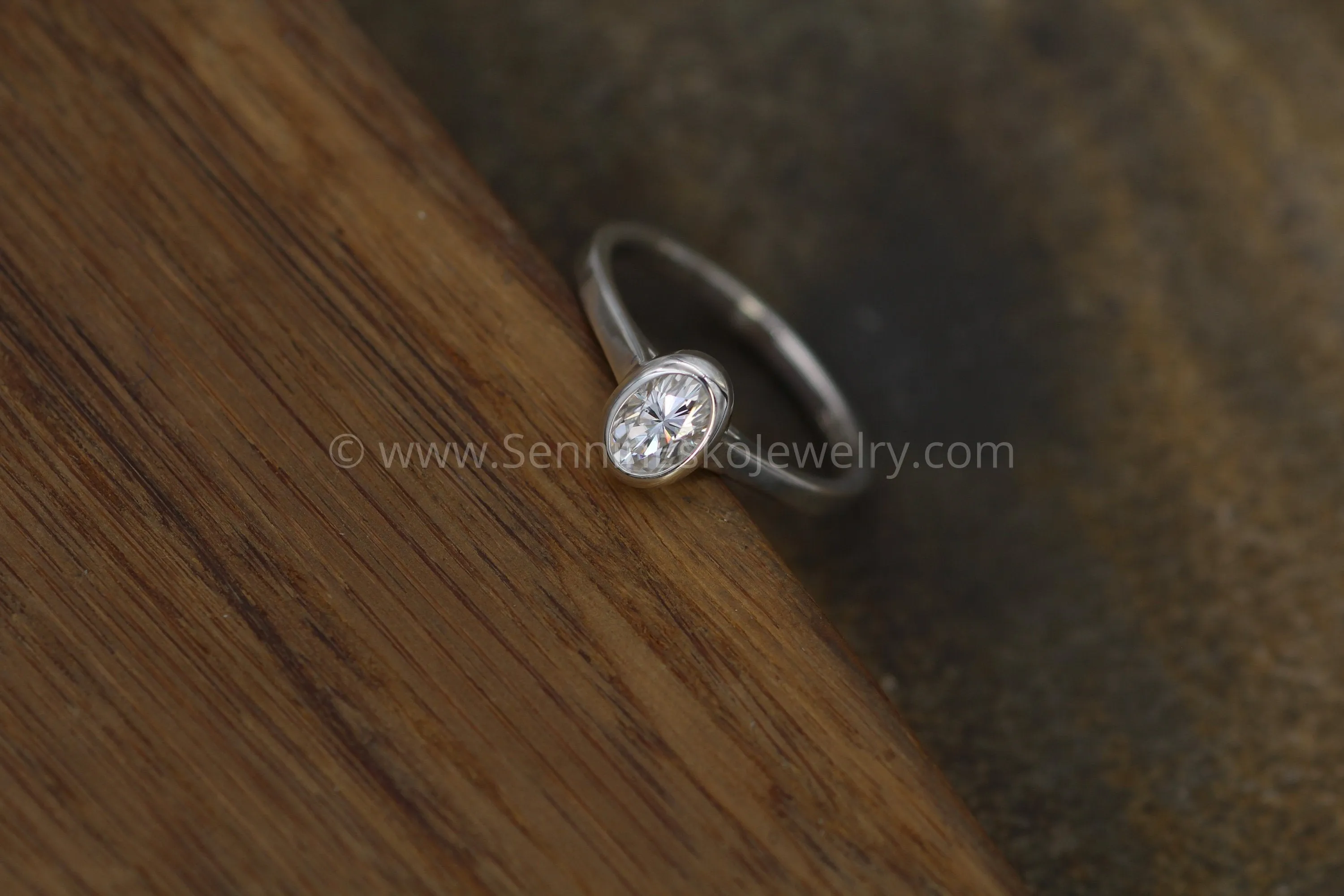 Moissanite 4x6mm Oval Peekaboo Bezel Solitaire Ring -  Forever One Moissanite