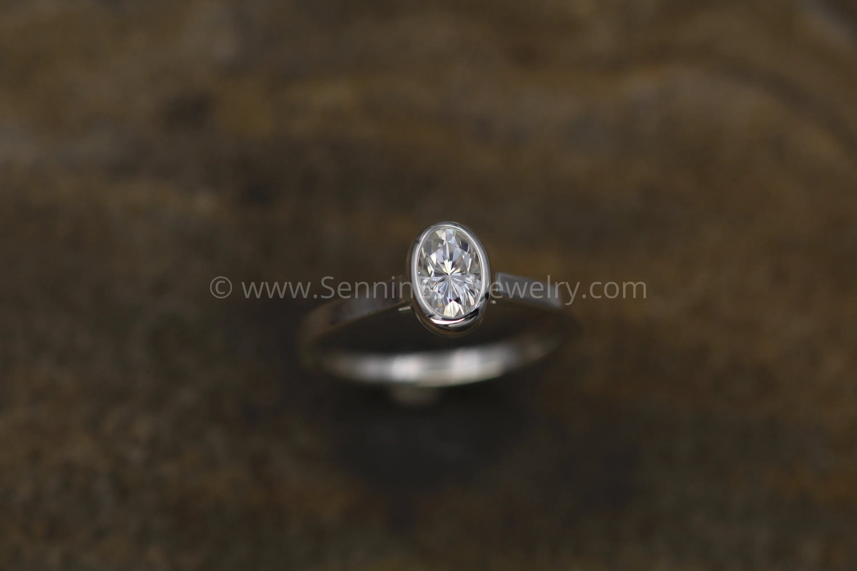 Moissanite 4x6mm Oval Peekaboo Bezel Solitaire Ring -  Forever One Moissanite